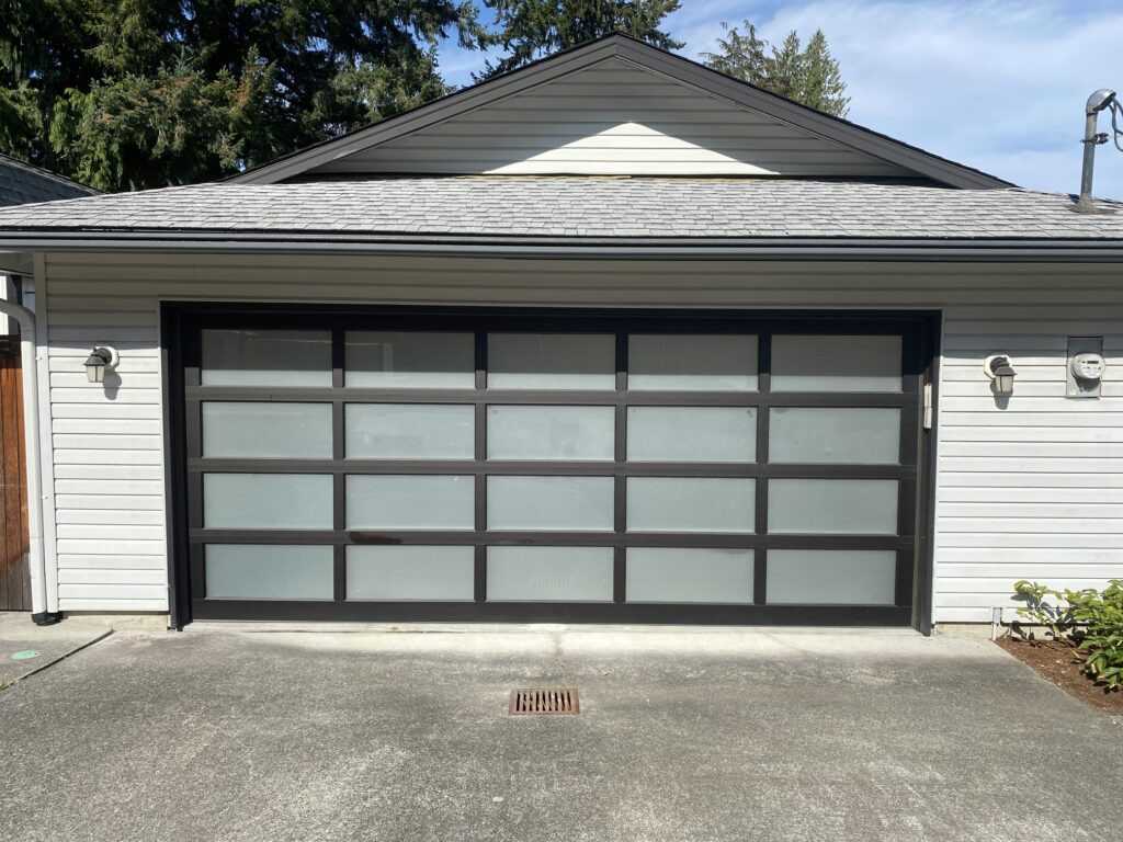 Elegant all-glass garage door installation for a modern home in Bellevue