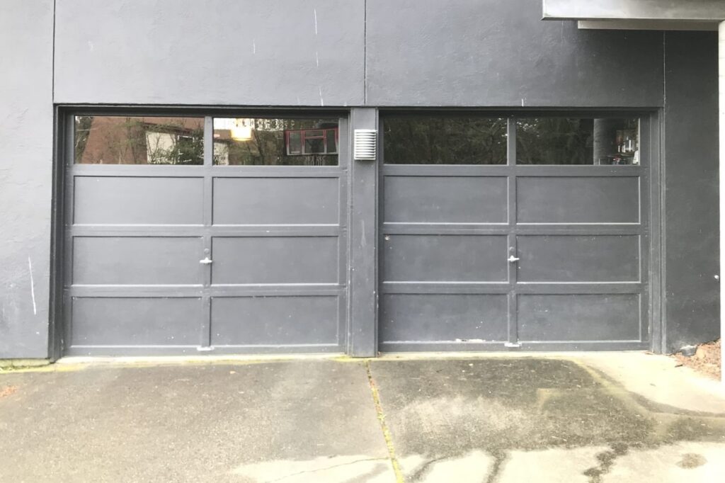 Before photo of old doors before modern glass garage door installation in Seattle