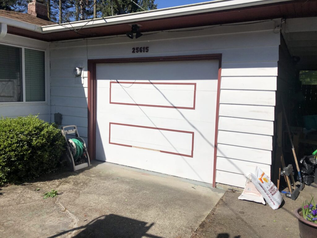 Before photo of a damaged garage door needing repair in Kent